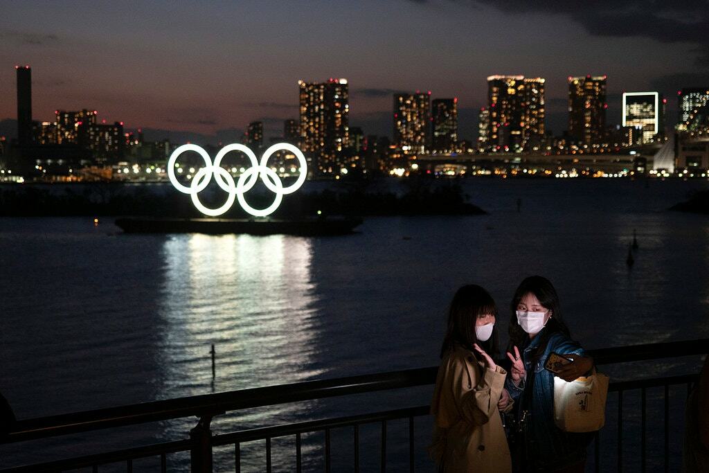 Người dân chụp ảnh với biểu tượng Olympic tại Tokyo. Ảnh: AP
